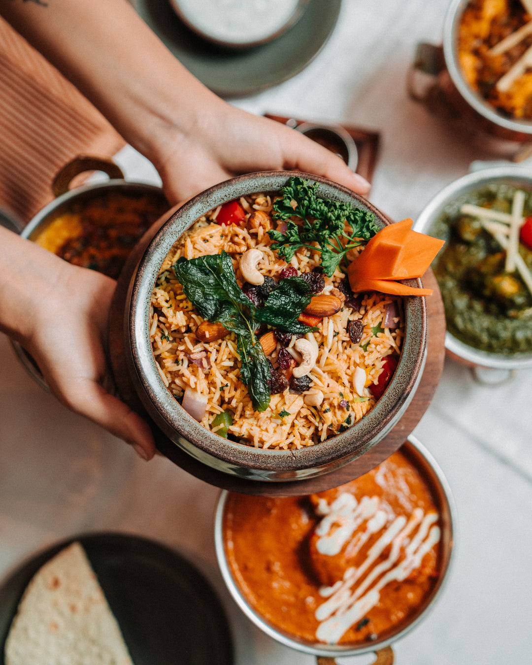 Biryani in a clay pot, served at the table