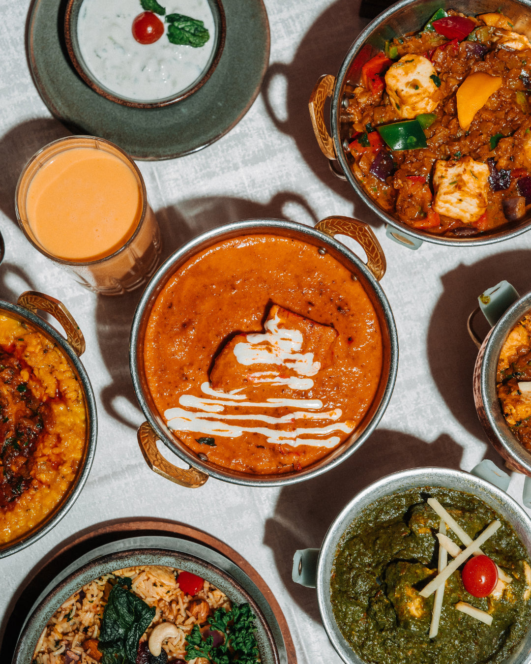 Table with biryani, curry and raita