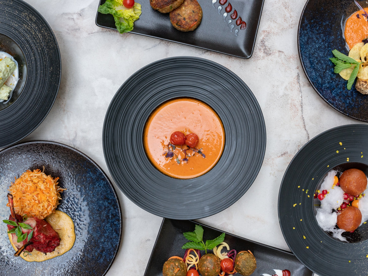 Several dishes on black plates